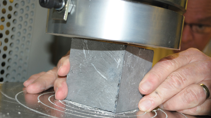 Technician performing dimension stone testing at Testhub Laboratories in Dubai, UAE