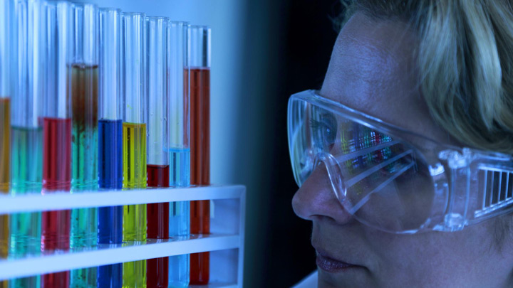 Laboratory technician conducting shelf life testing on packaged food and beverage products