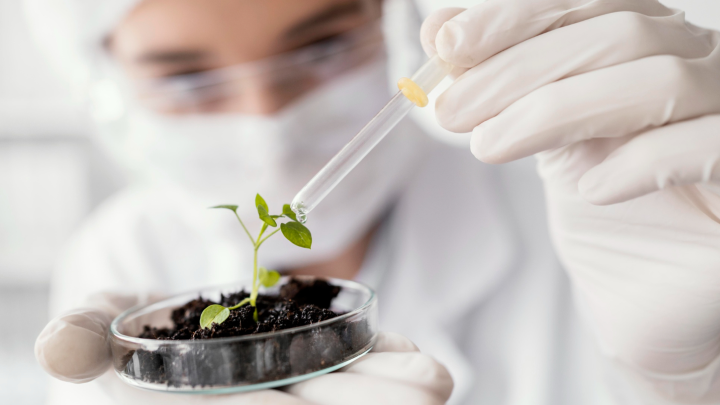 Laboratory technician analyzing water sample for environmental contaminants using modern testing equipment