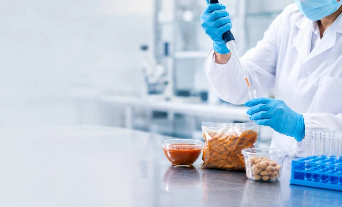 Lab technician testing a food sample for allergens in an accredited food testing lab in Dubai